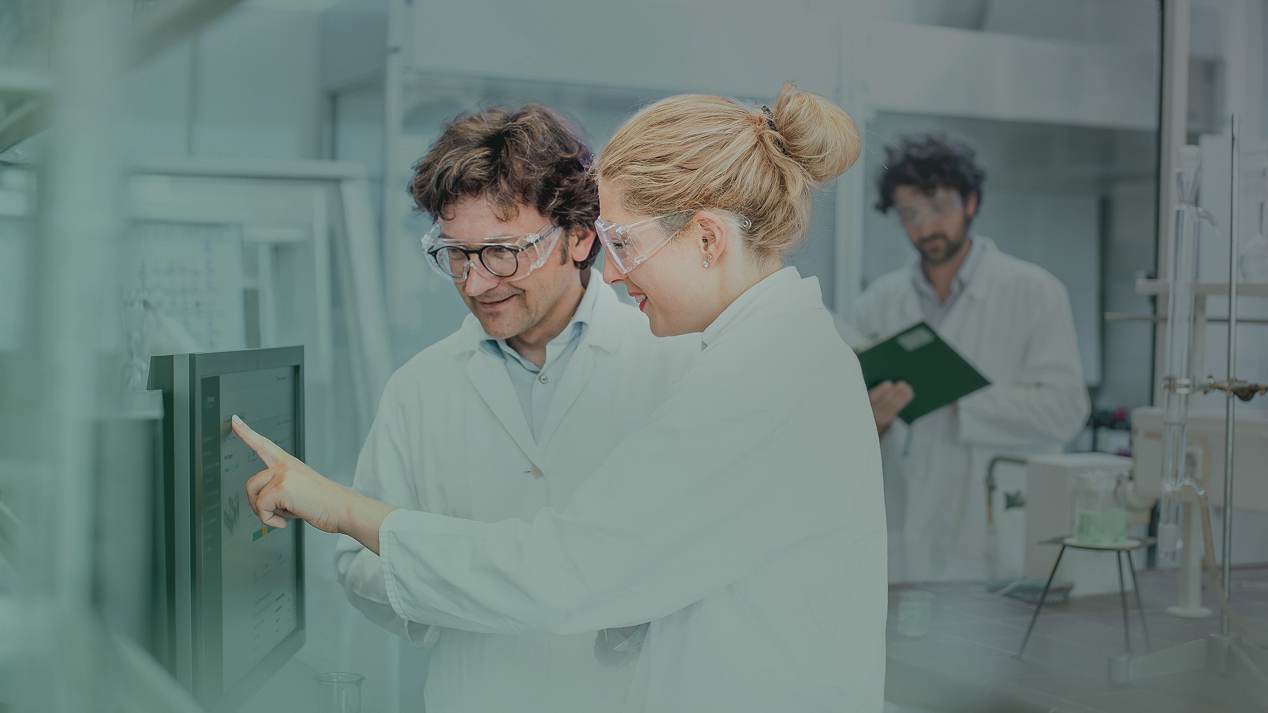 Scientists are working in a laboratory, using a computer.